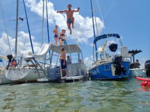 2023 summer sailstice raft up with kid jumping